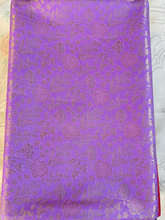 Purple fabric with floral pattern on a white background
