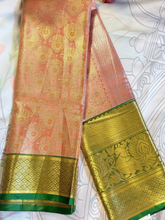 Traditional saree with pink and green patterns on a white background