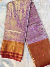 Purple and gold saree with a decorative border on a white background