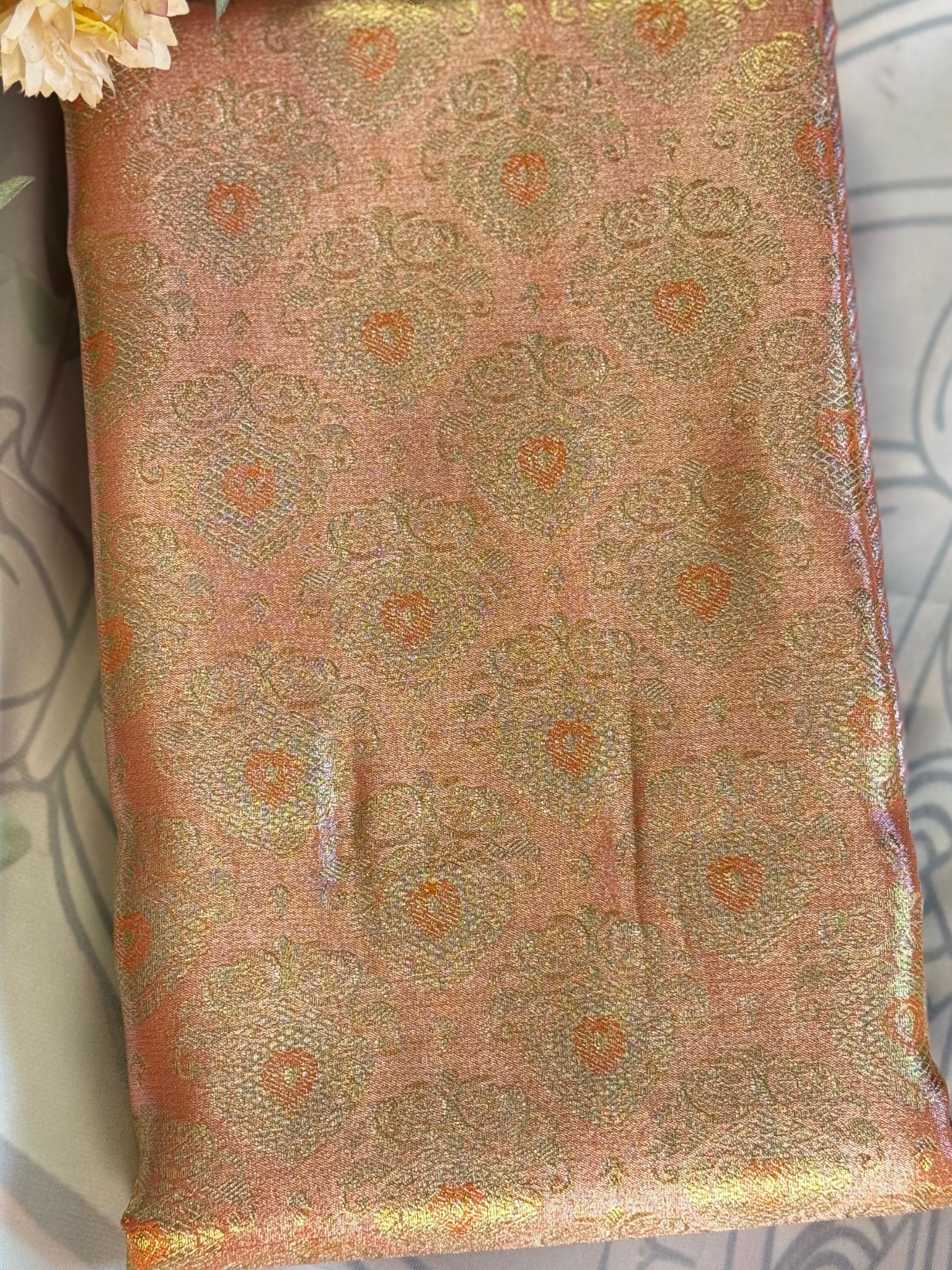 Decorative fabric with intricate patterns on a textured surface