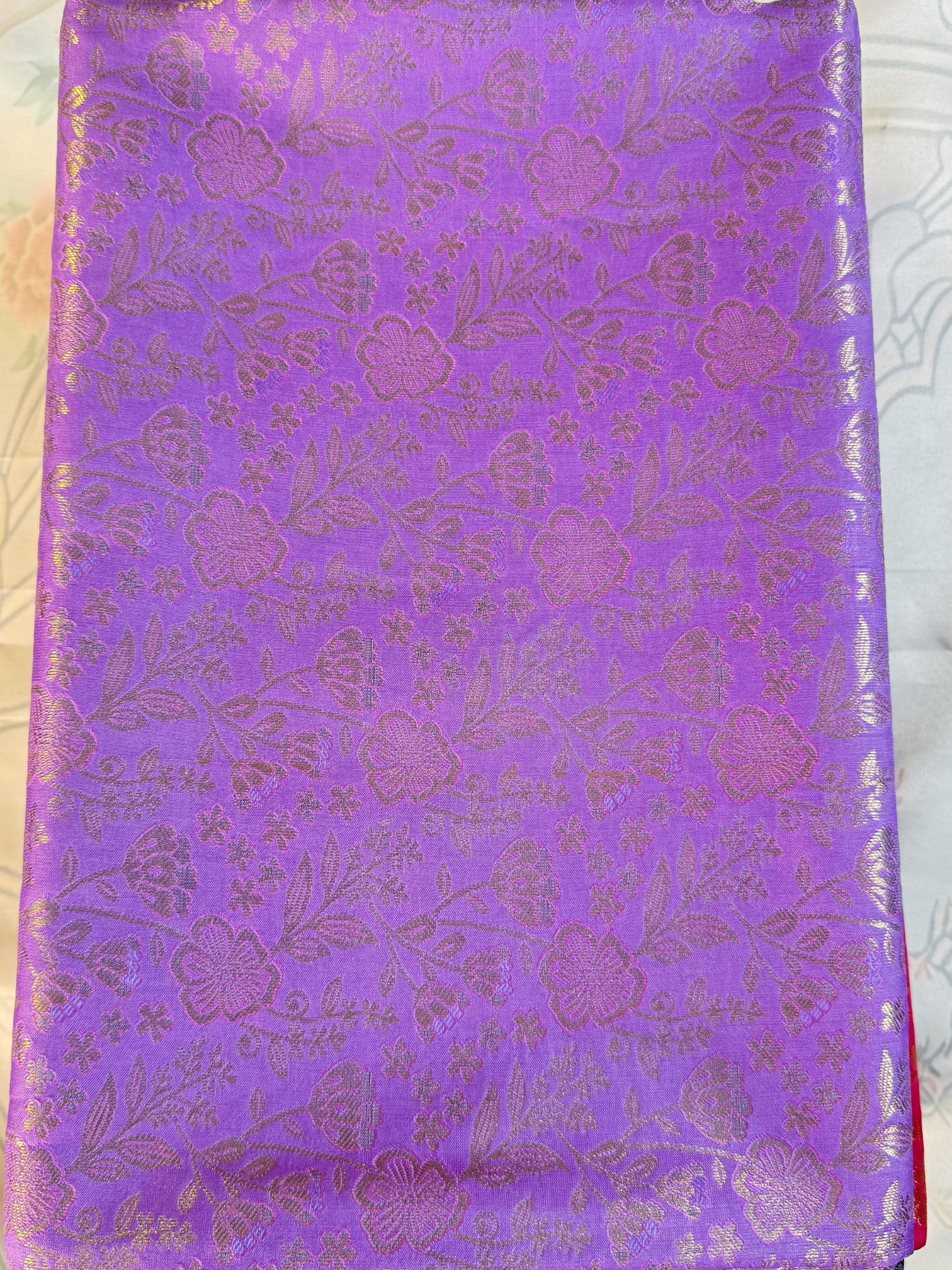 Purple fabric with floral pattern on a white background