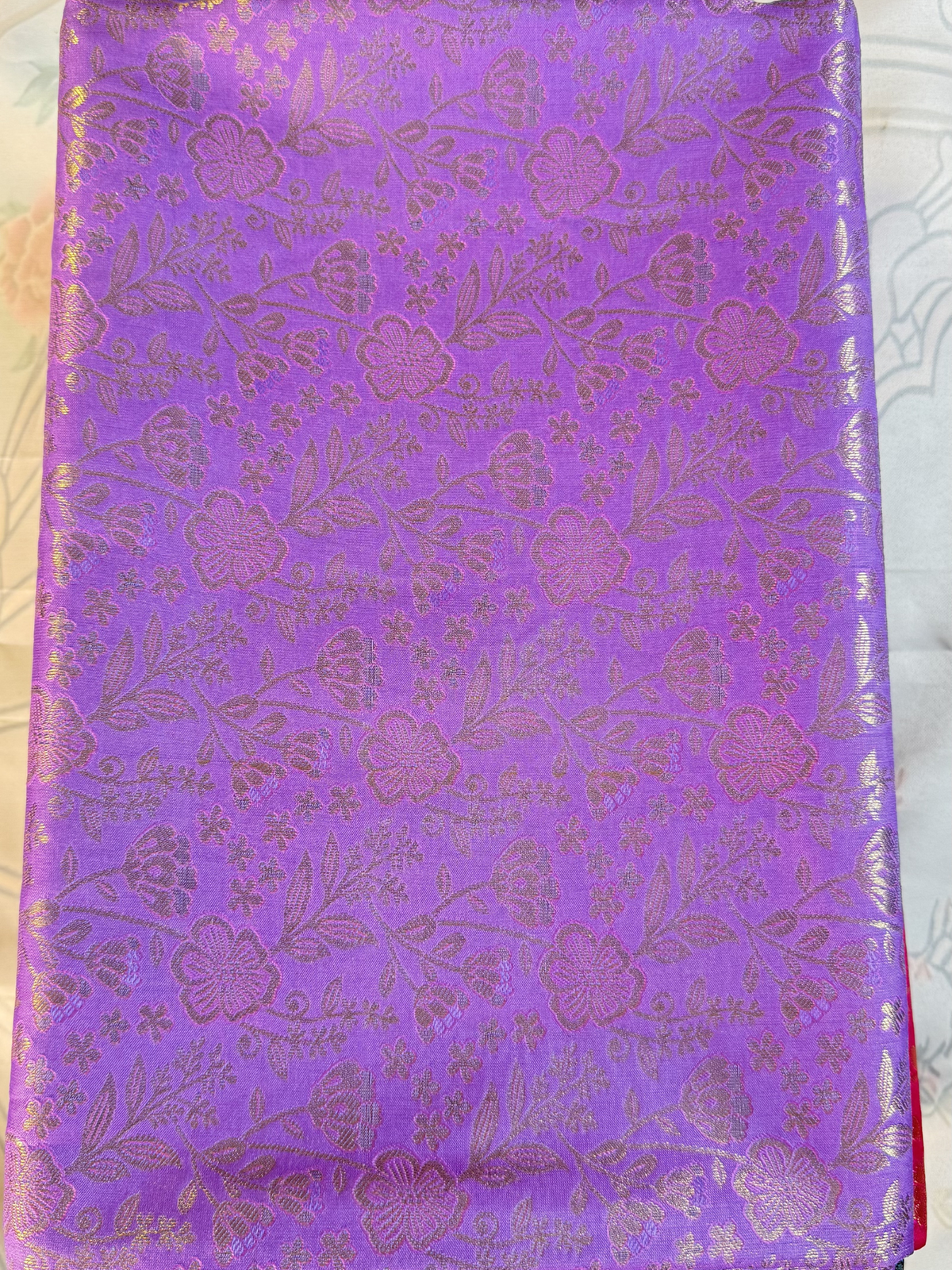 Purple fabric with floral pattern on a white background