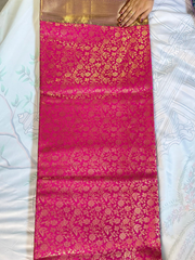 Pink saree with gold patterns on a white background
