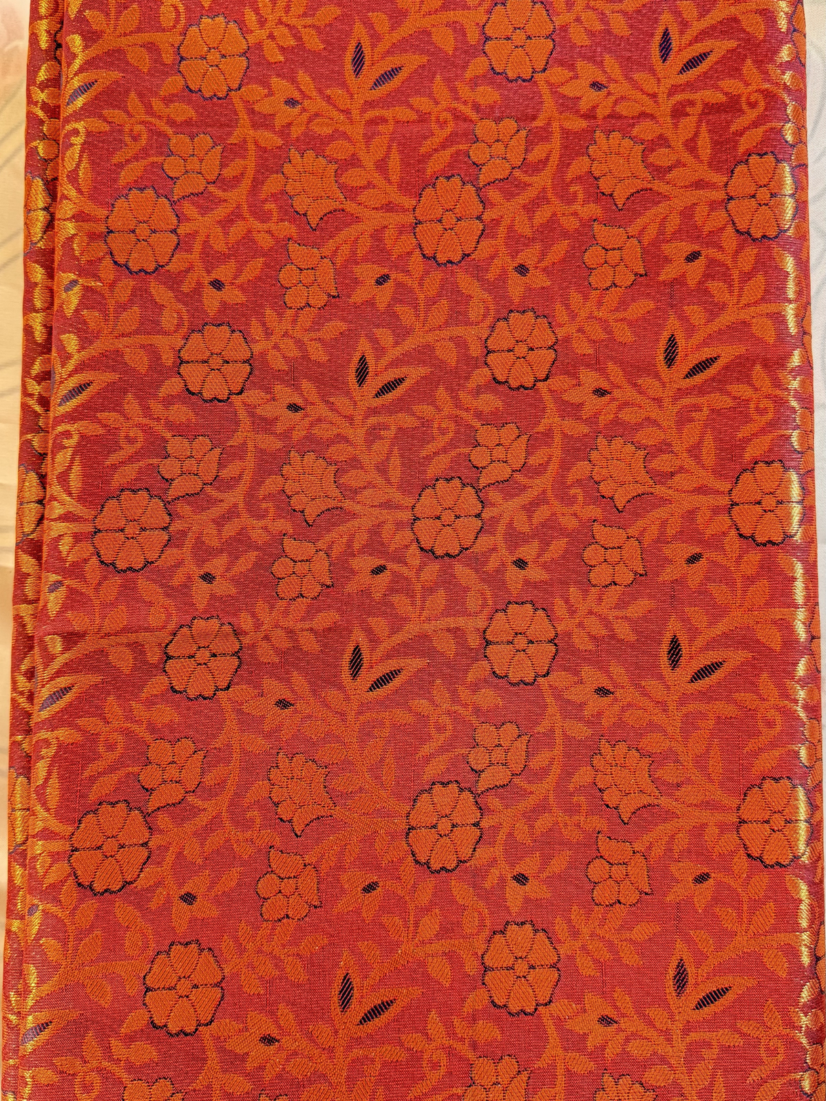 Red fabric with black floral pattern