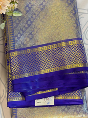 Blue and gold saree with a visible brand label on a light background