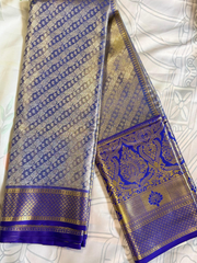 Blue and gold patterned fabric on a white background