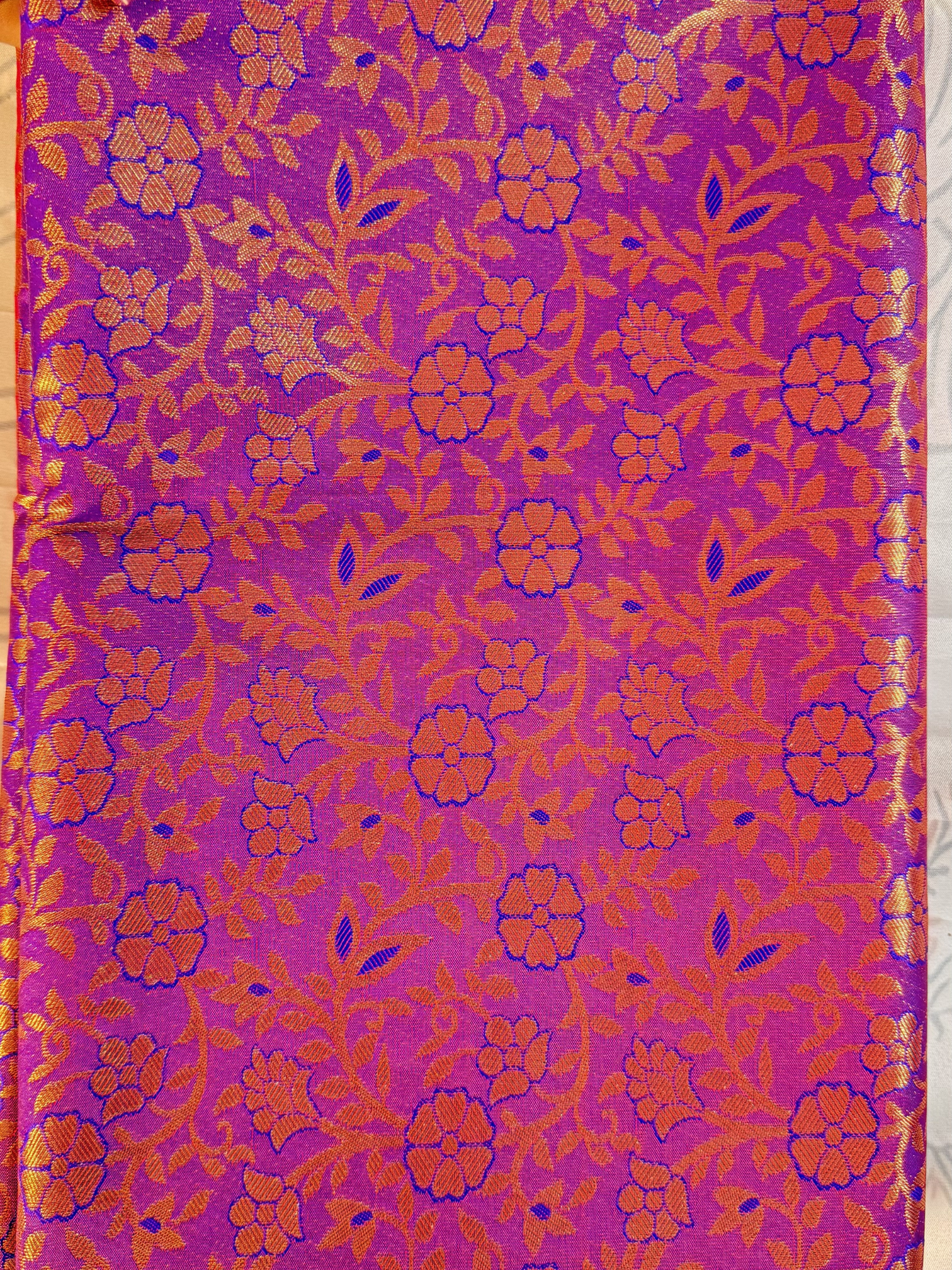 Purple fabric with orange floral pattern