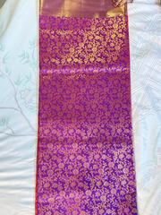 Purple fabric with gold floral patterns on a white surface