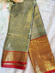 Traditional saree with gold and red border on a white background