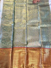 Traditional saree with intricate patterns and a gold border.