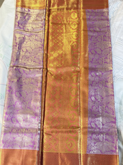 Saree with purple and gold patterns on a white background
